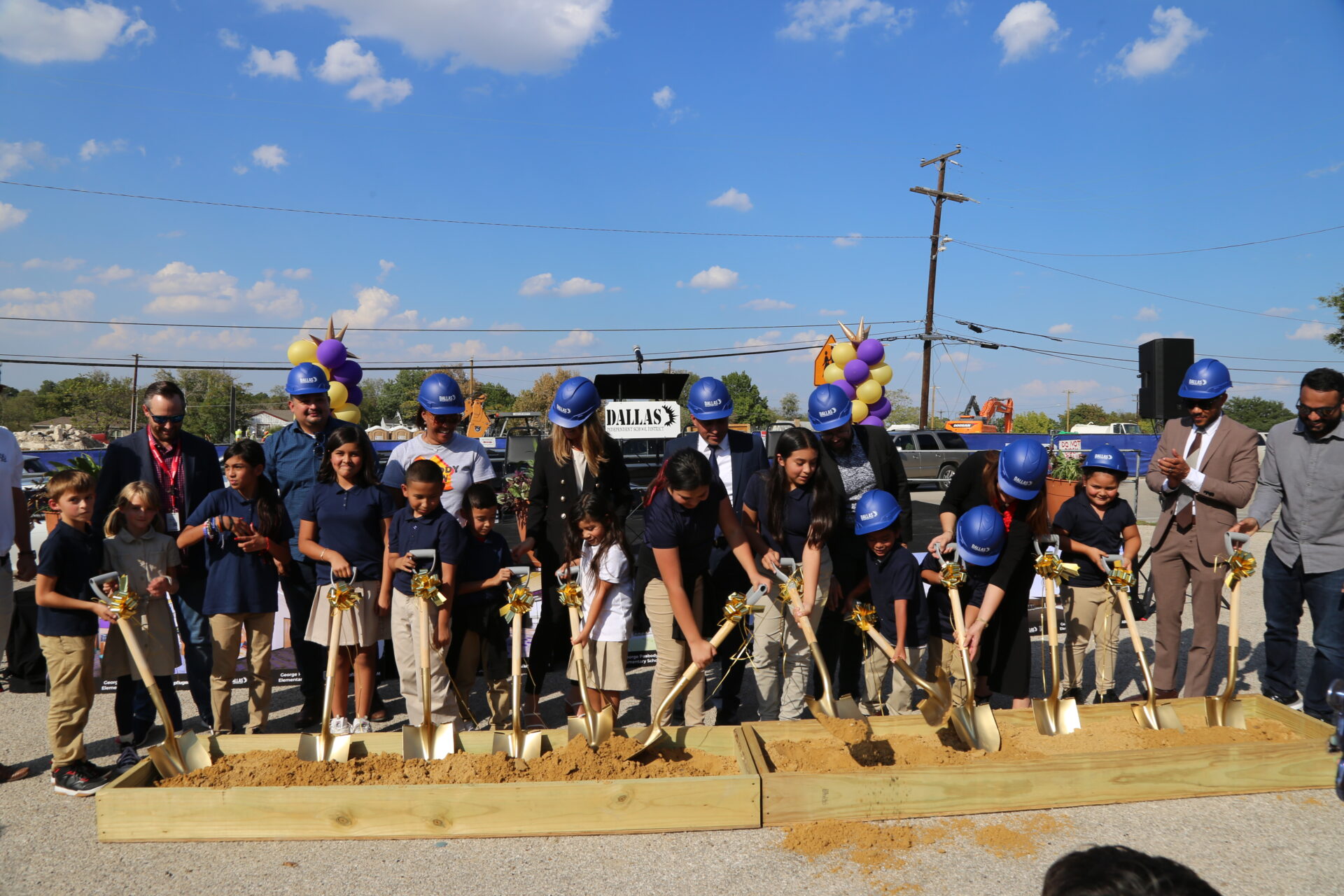 Students helping shovel at the groundbreaking for Dallas ISD's George Peabody Elementary